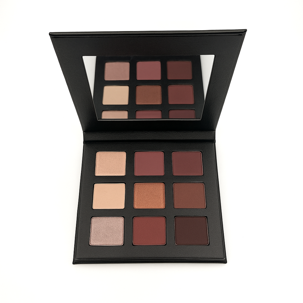 Makeup palette with various shades of eyeshadows in matte shimmer pink and nudes on a white background