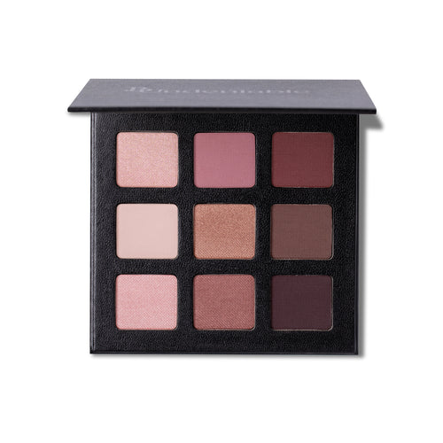 A 9-shade eyeshadow palette in a textured black compact, shown open against a white background. The shades range from light pinks and beiges to medium and deep browns and purples.