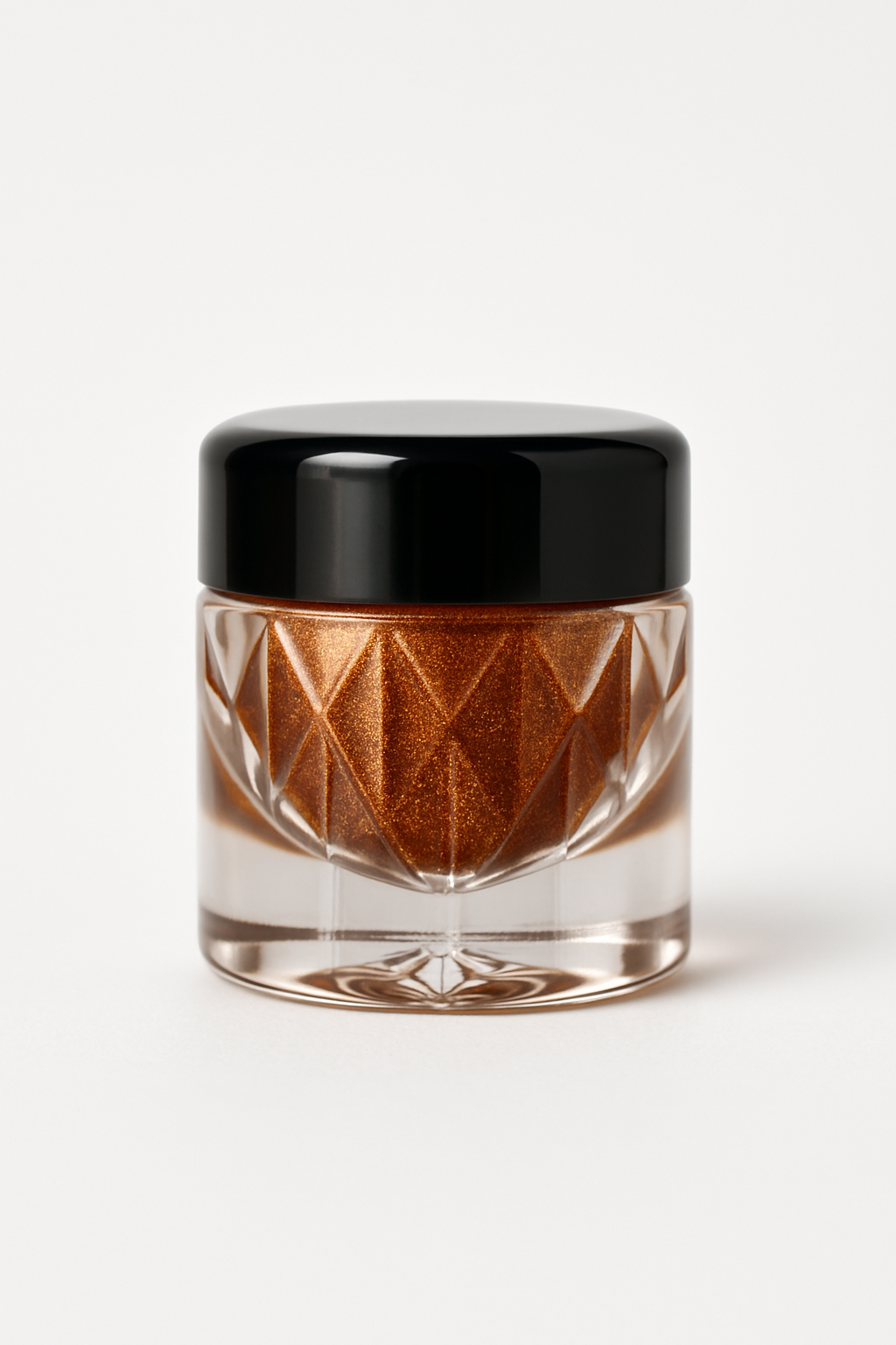 Small glass jar with black lid containing a brown powder on a white background