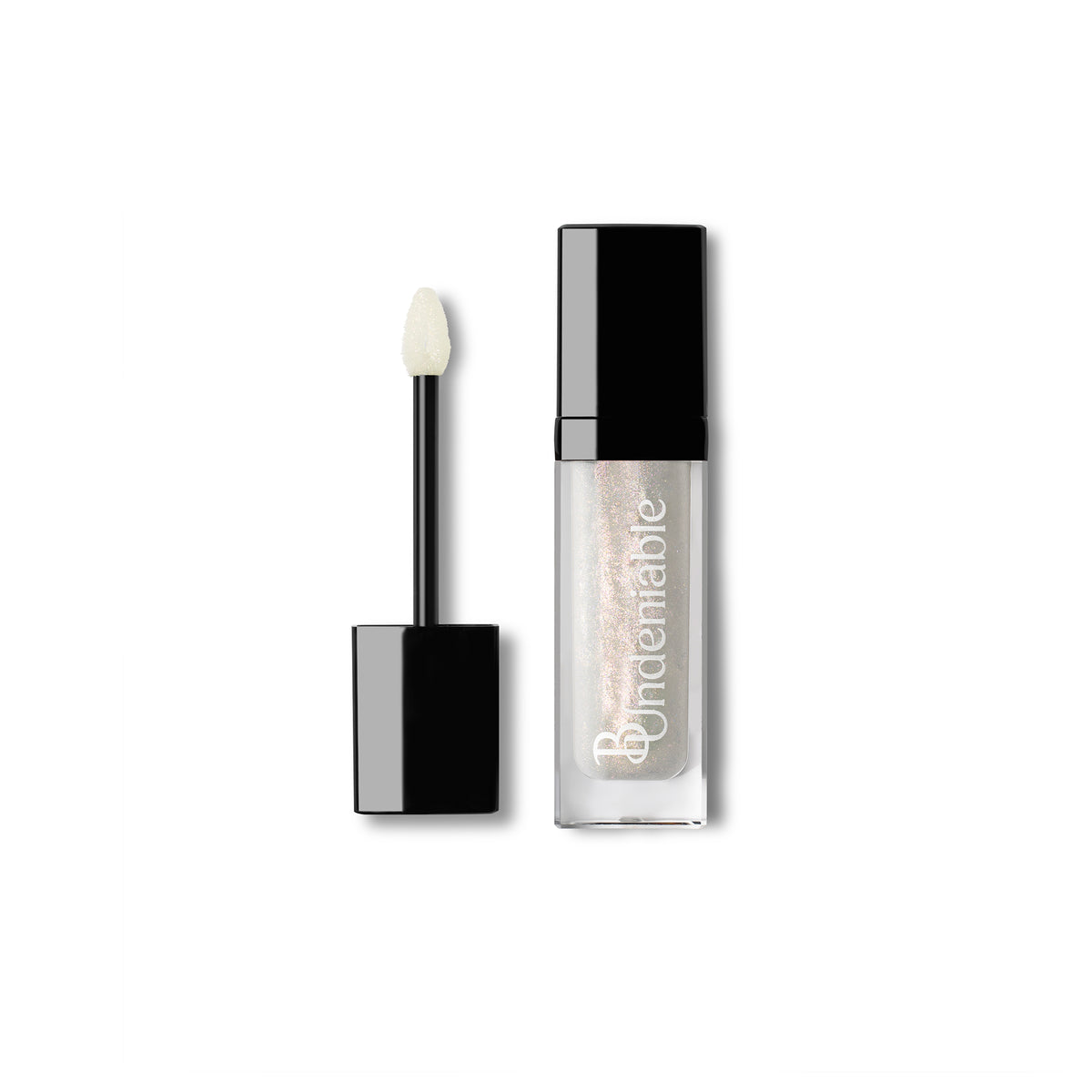 A clear rectangular cosmetic tube with a black cap, shown next to its applicator wand with a black handle and cream-colored tip. The tube contains a shimmering light champagne-pink liquid and features the brand name 'B:Undeniable' printed vertically in white.