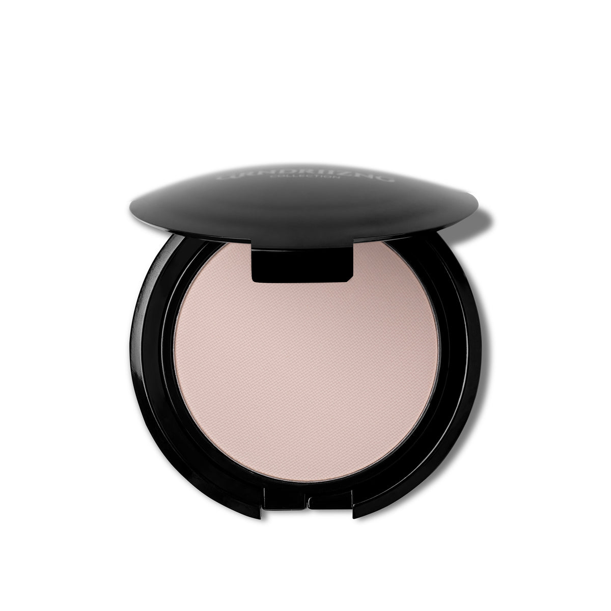 An open round makeup compact showing a light neutral pressed powder, with a glossy black lid resting above it on a white background.
