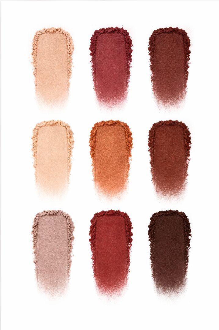 Set of nine makeup swatches in various shades of brown and red on a white background