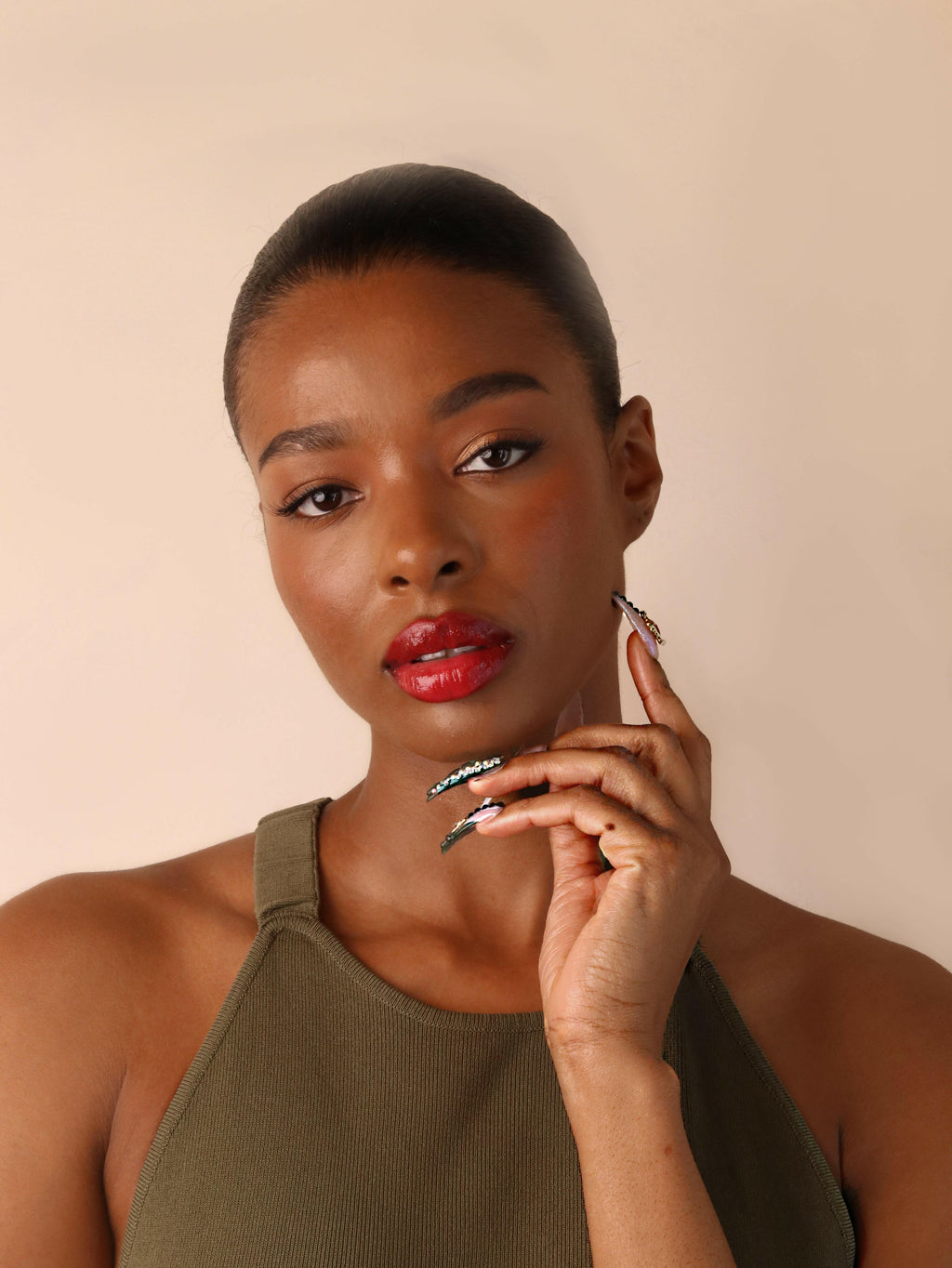 Woman wearing red lipstick with a neutral background
