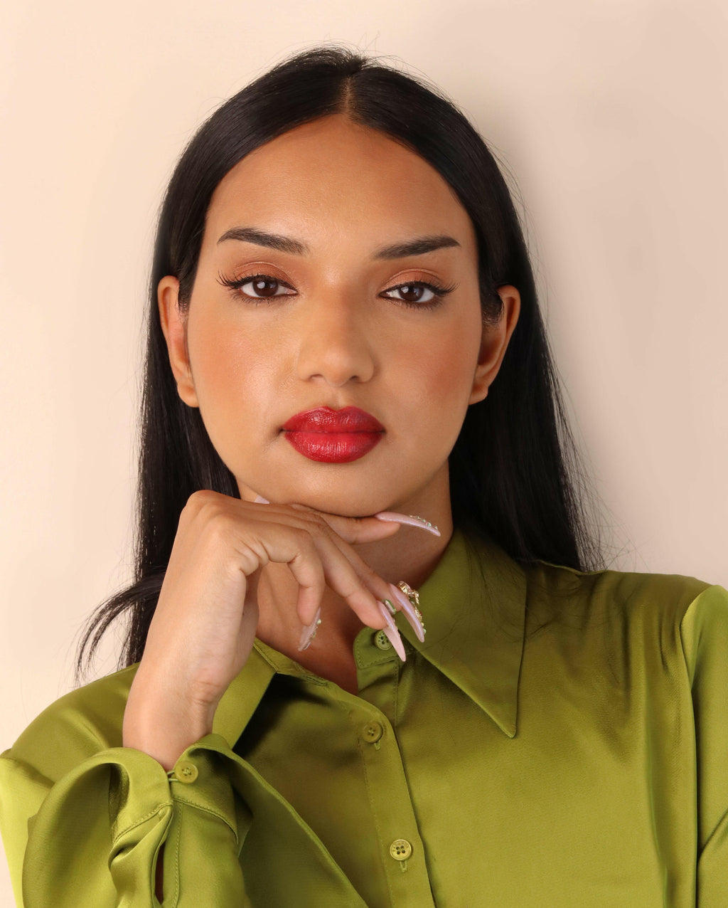 Woman wearing a green shirt with a plain background
